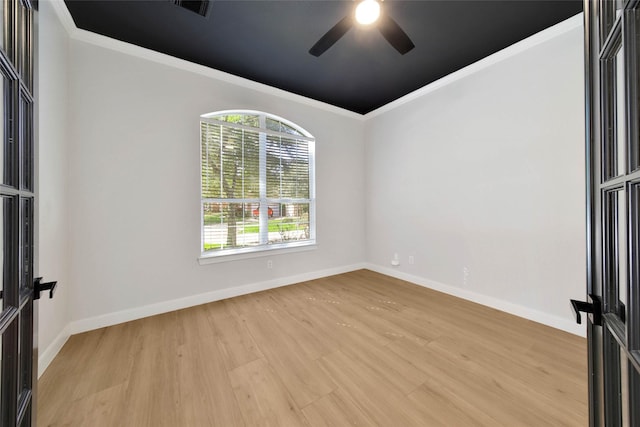 unfurnished room featuring ceiling fan, visible vents, baseboards, ornamental molding, and light wood finished floors