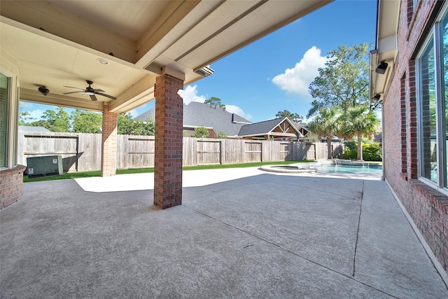 view of patio / terrace featuring a fenced in pool, a fenced backyard, ceiling fan, and an in ground hot tub