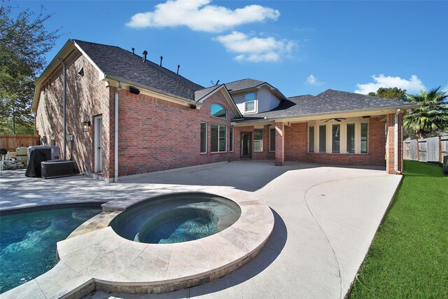 back of house with brick siding, a patio area, fence, and a ceiling fan