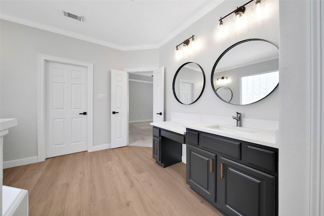 full bath with baseboards, visible vents, ornamental molding, wood finished floors, and vanity