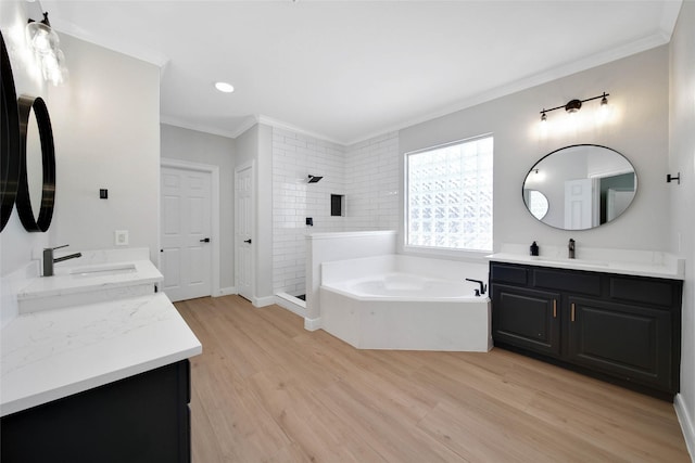 full bath with ornamental molding, a stall shower, a sink, and a bath