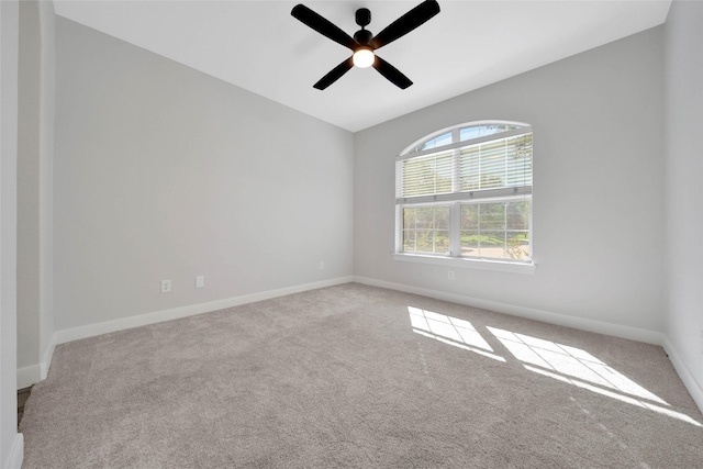 empty room with ceiling fan, baseboards, and carpet flooring