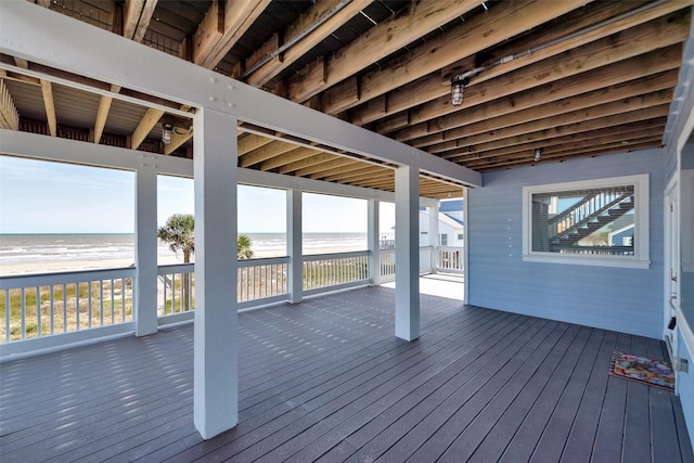 deck featuring a water view and a view of the beach