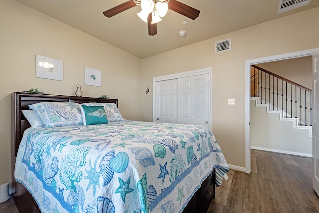 bedroom featuring baseboards, a closet, visible vents, and dark wood-type flooring