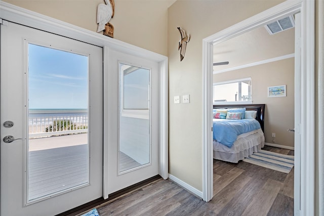 doorway featuring visible vents, plenty of natural light, and wood finished floors