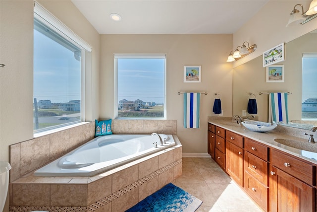 bathroom featuring double vanity, a garden tub, a sink, and tile patterned floors