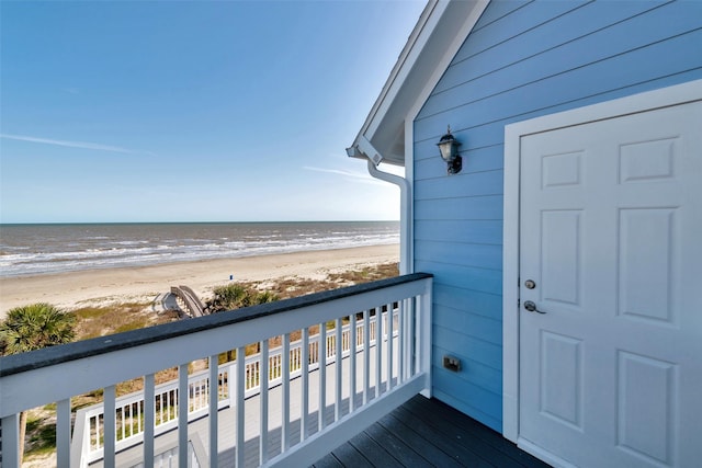 balcony with a water view and a beach view