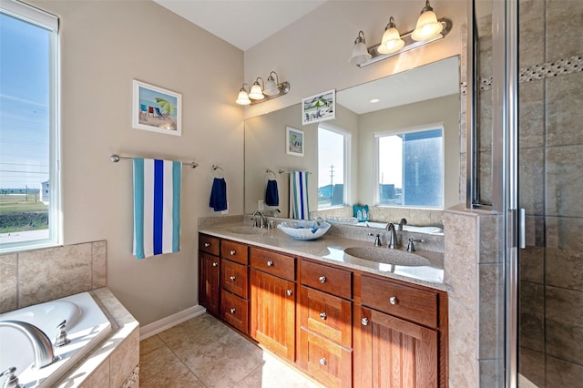 bathroom featuring double vanity, a garden tub, a sink, and tile patterned floors