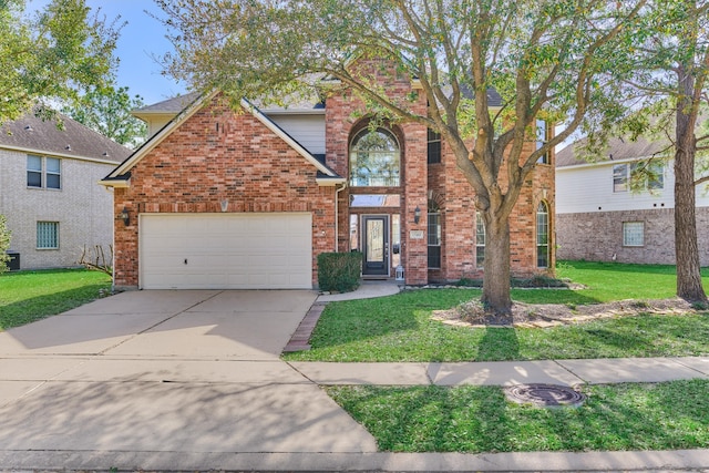 traditional home with brick siding, an attached garage, driveway, and a front lawn