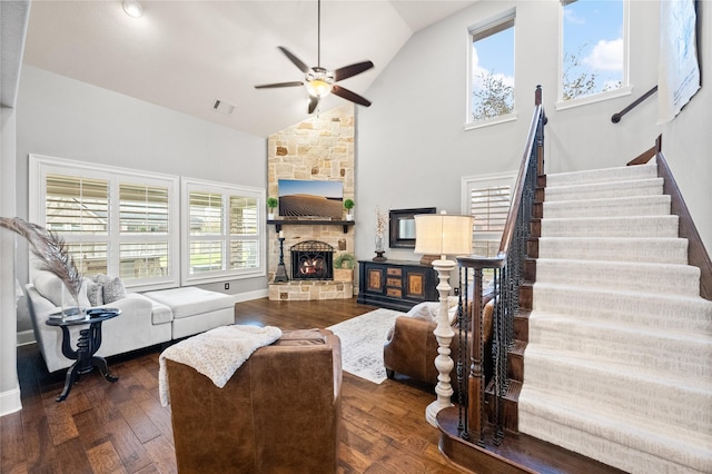 living room with a fireplace, wood-type flooring, visible vents, stairway, and high vaulted ceiling