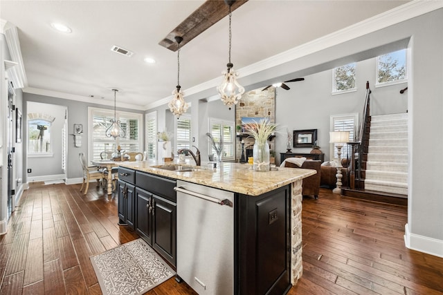 kitchen featuring visible vents, dark wood finished floors, dishwasher, dark cabinetry, and a sink