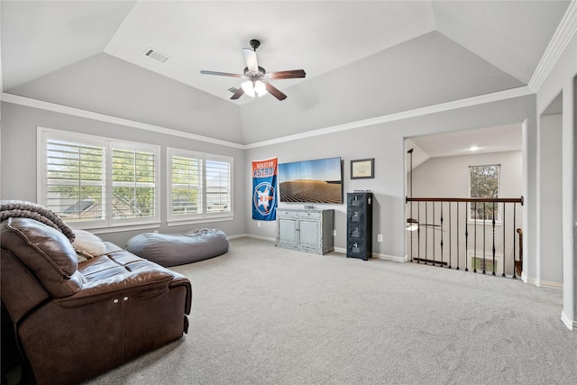 carpeted living room featuring baseboards, visible vents, a ceiling fan, vaulted ceiling, and crown molding