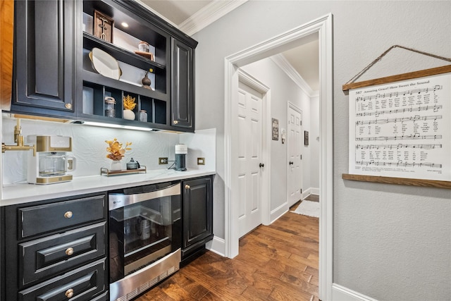 bar featuring ornamental molding, beverage cooler, baseboards, and dark wood-style floors