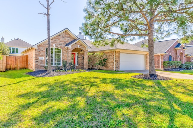 view of front of home with brick siding, a front lawn, an attached garage, and fence