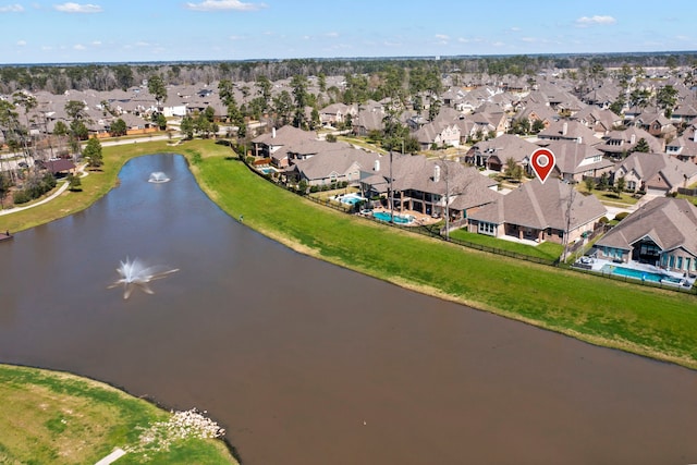 drone / aerial view featuring a residential view and a water view