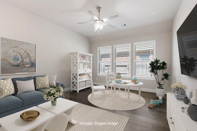 living area featuring vaulted ceiling, visible vents, baseboards, and dark wood-style flooring