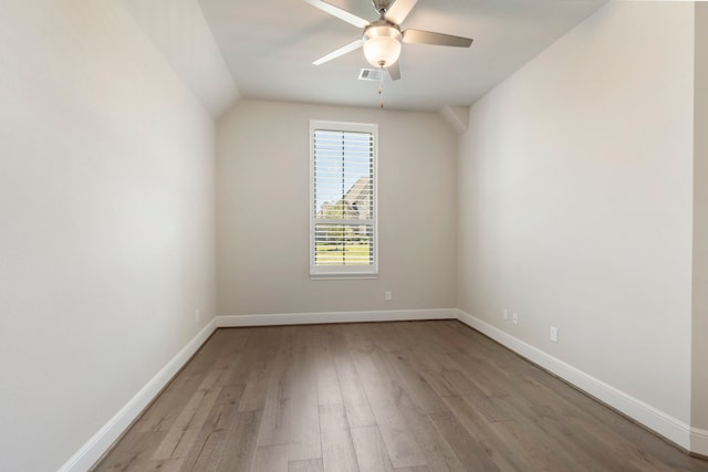 unfurnished room featuring vaulted ceiling, a ceiling fan, light wood-type flooring, and baseboards