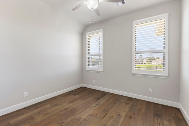 spare room with hardwood / wood-style floors, a healthy amount of sunlight, visible vents, and baseboards