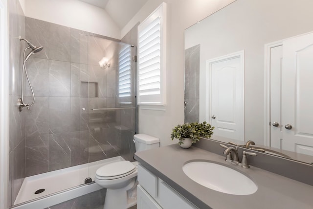 full bath featuring a tile shower, toilet, and vanity