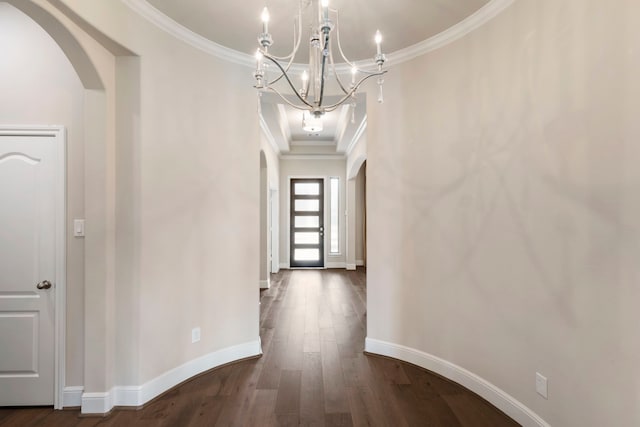 hallway with baseboards, arched walkways, dark wood-style flooring, and ornamental molding