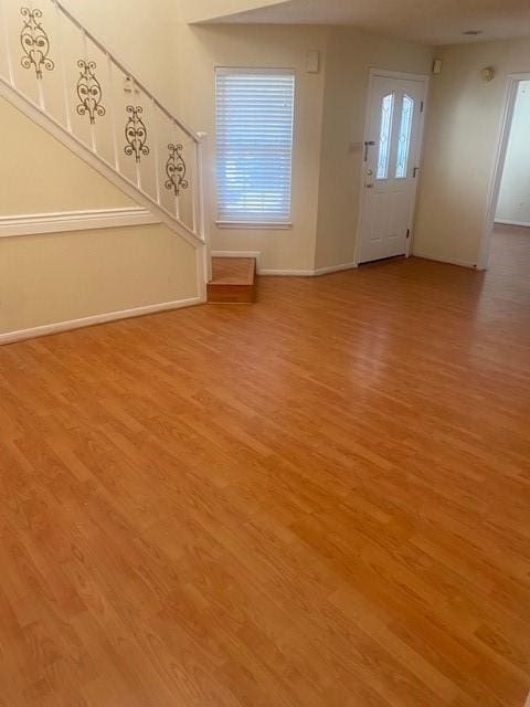 entrance foyer featuring light wood-type flooring and baseboards