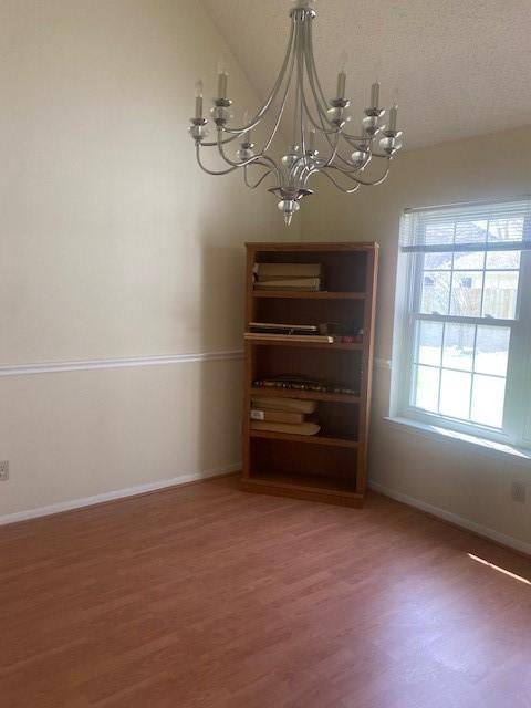 unfurnished dining area featuring light wood-type flooring and baseboards