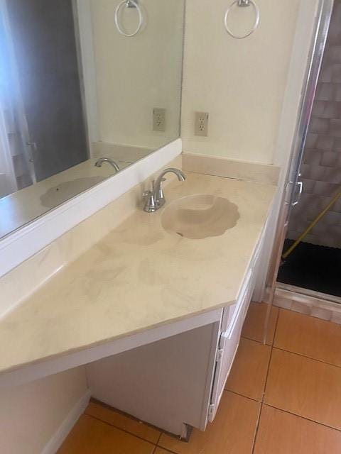 bathroom featuring tile patterned flooring and vanity