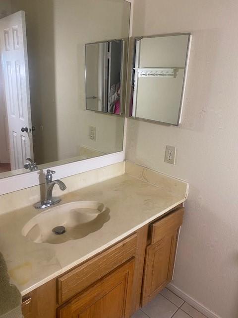 bathroom featuring tile patterned flooring and vanity