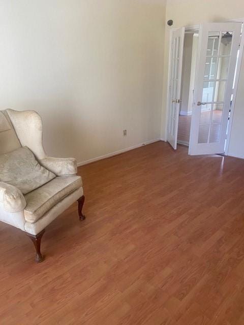 living area featuring light wood-type flooring and baseboards