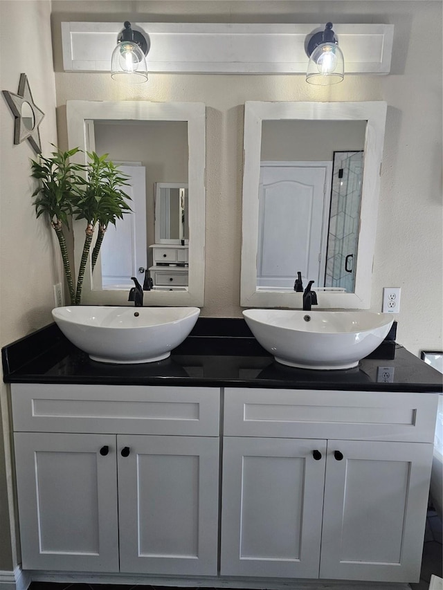 full bathroom with double vanity and a sink