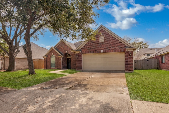 view of front of house featuring an attached garage, brick siding, fence, driveway, and a front lawn