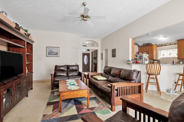 living area with light carpet and ceiling fan