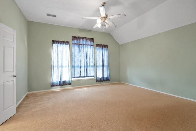 spare room featuring light carpet, ceiling fan, visible vents, and baseboards