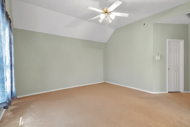 additional living space featuring visible vents, baseboards, light colored carpet, lofted ceiling, and ceiling fan