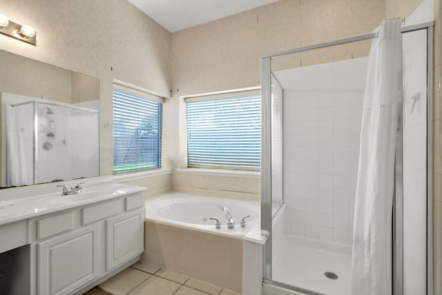 full bathroom featuring a shower stall, vanity, a bath, and tile patterned floors