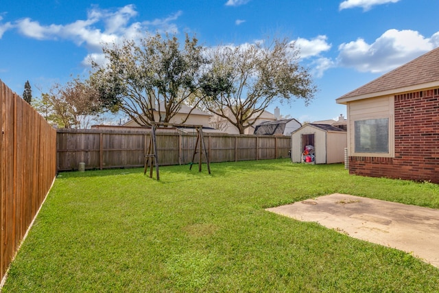 view of yard with a storage shed, a fenced backyard, a patio area, and an outdoor structure