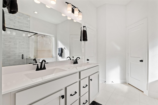 bathroom featuring tile patterned flooring, a sink, a shower stall, and double vanity