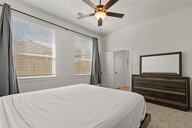 bedroom featuring carpet floors, ceiling fan, and visible vents