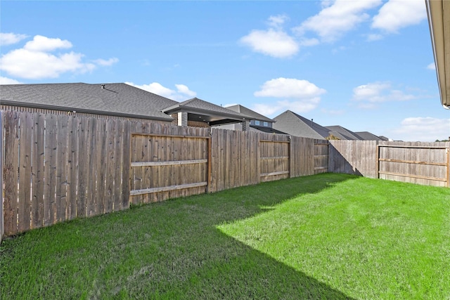 view of yard with a fenced backyard