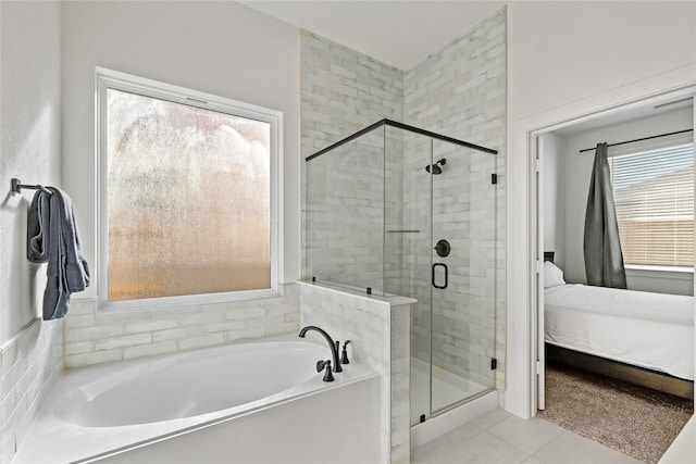 bathroom with ensuite bathroom, a stall shower, a garden tub, and tile patterned floors