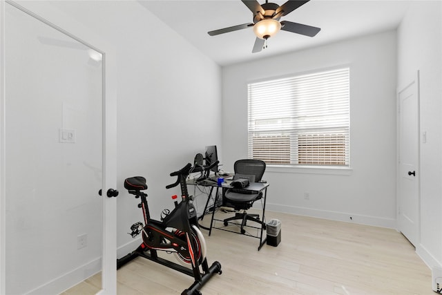 exercise area featuring ceiling fan, wood finished floors, and baseboards