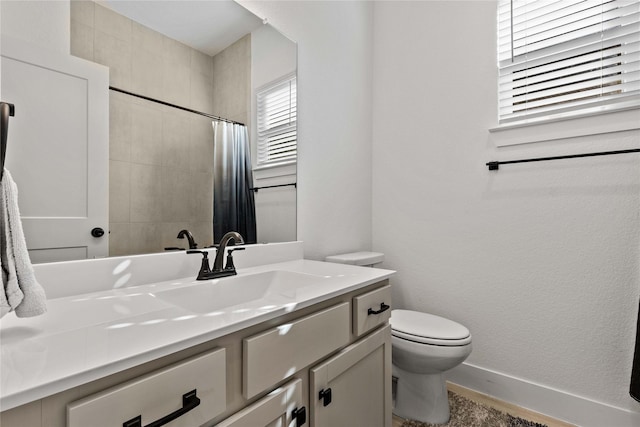 bathroom with toilet, curtained shower, vanity, and baseboards