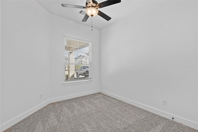 empty room with carpet floors, visible vents, ceiling fan, and baseboards