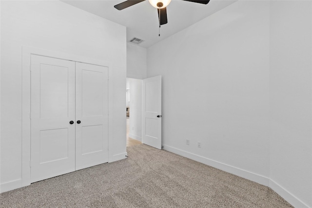 unfurnished bedroom featuring a closet, visible vents, carpet flooring, ceiling fan, and baseboards