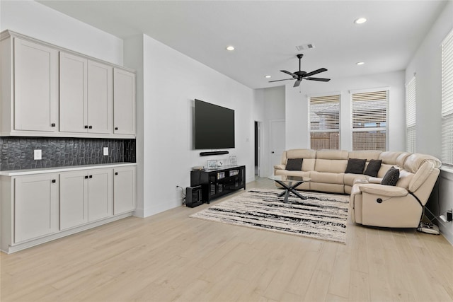 living room with ceiling fan, light wood-type flooring, visible vents, and recessed lighting