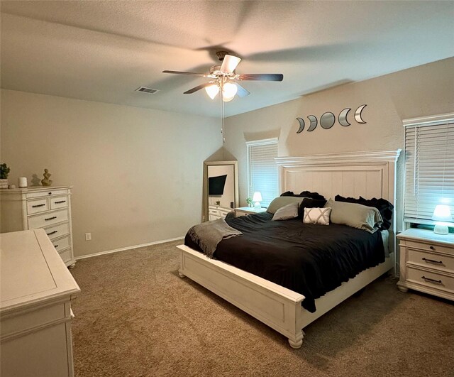 bedroom with baseboards, visible vents, dark colored carpet, and ceiling fan