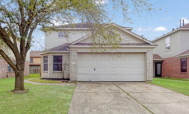 traditional-style home with a garage, driveway, brick siding, and a front yard