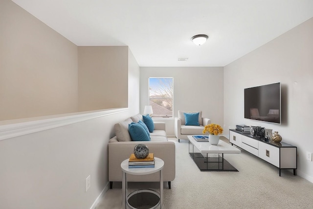 carpeted living room featuring visible vents and baseboards