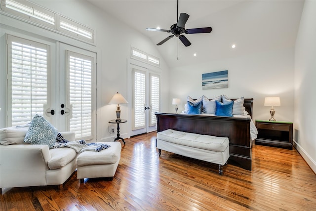 bedroom with lofted ceiling, access to exterior, wood finished floors, and french doors