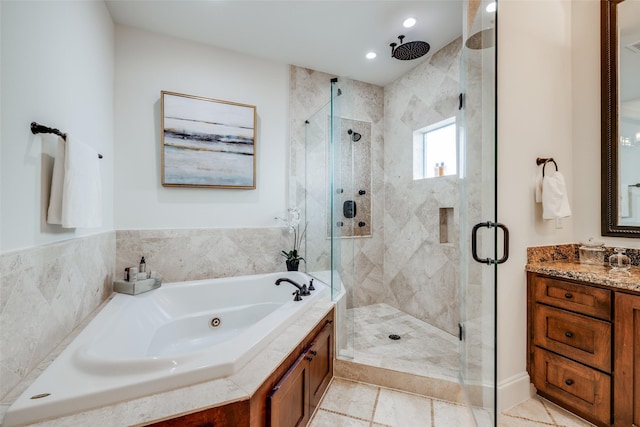 bathroom with a stall shower, recessed lighting, a tub with jets, and vanity